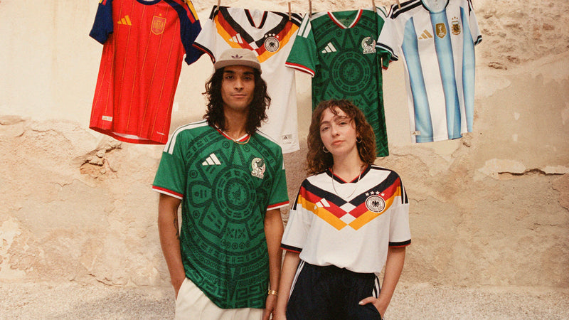 Two people wearing soccer jerseys with a collage of various national team jerseys in the background.